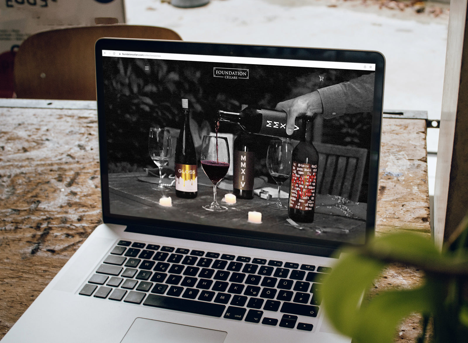 Laptop displaying wine poured into glass. 